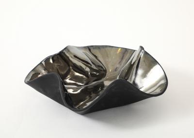 Decorative free form twist bowl in a highly reflective platinum finish