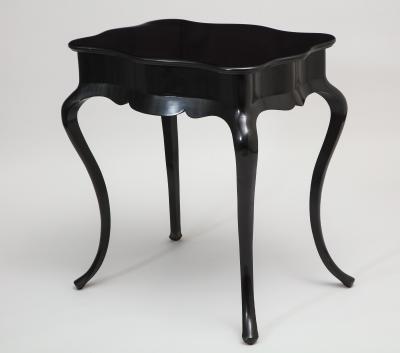 Dramatic ebonized side table with bat drawer pull