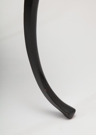Dramatic ebonized side table with bat drawer pull