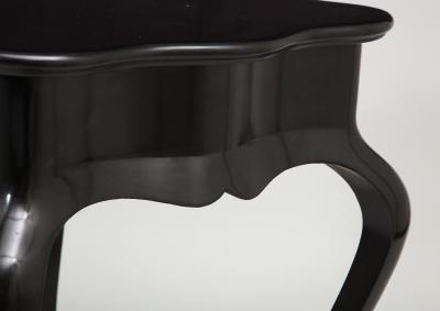 Dramatic ebonized side table with bat drawer pull