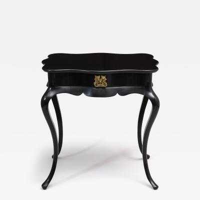 Dramatic ebonized side table with bat drawer pull