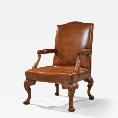 EARLY 20TH CENTURY WALNUT CARVED LEATHER UPHOLSTERY ARMCHAIR