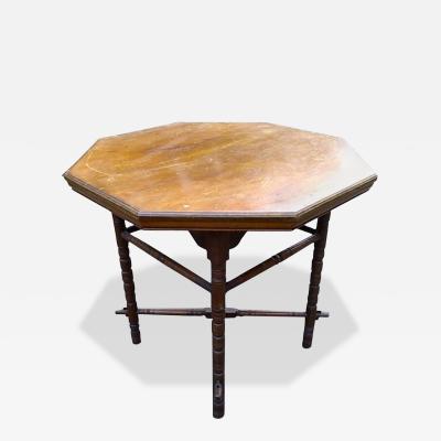 Edward William Godwin E W Godwin an Aesthetic Movement Walnut Octagonal Table with Crossed Stretcher