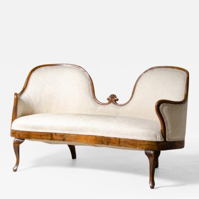 Elegant two seater sofa in carved walnut and fabric