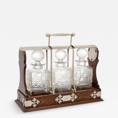 English 19th Century Victorian Locking Tantalus with Three Cut Glass Decanters