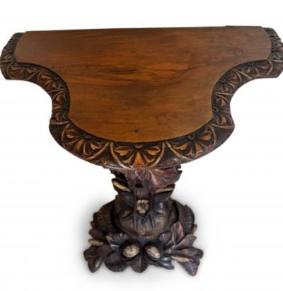 English Regency console with a carved bird floral base over a shaped top