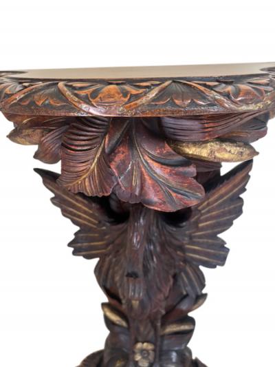 English Regency console with a carved bird floral base over a shaped top