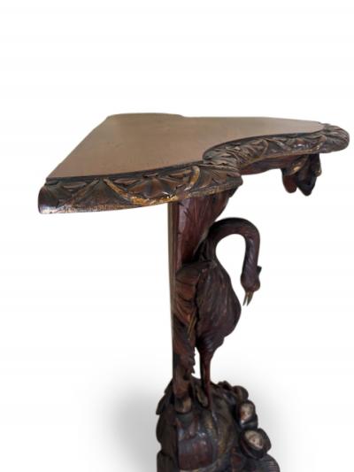 English Regency console with a carved bird floral base over a shaped top