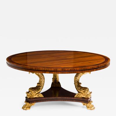 English Regency style rosewood center table with 3 gilt dolphins