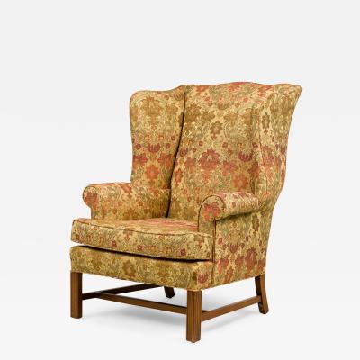 English Victorian Beige Wingback Chair With Various Colored Floral Pattern