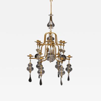 Erik H glund A gilt wrought iron and glass chandelier by Erik Hoglund for Boda 