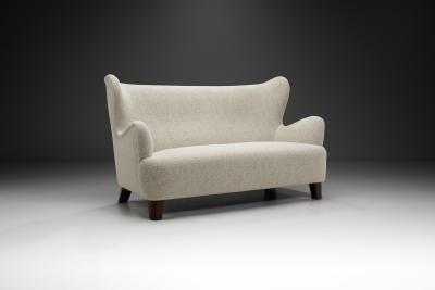 European Upholstered Wingback Sofa with Stained Wood Feet Europe 20th Century