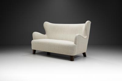 European Upholstered Wingback Sofa with Stained Wood Feet Europe 20th Century