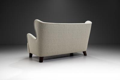 European Upholstered Wingback Sofa with Stained Wood Feet Europe 20th Century