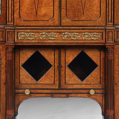 FINE REGENCY AMBOYNA AND EBONY INLAID GILT BRONZE MOUNTED SHAPED CABINET