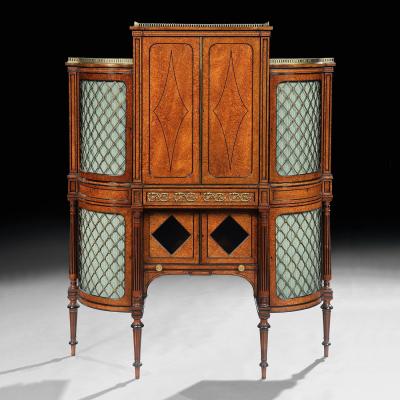 FINE REGENCY AMBOYNA AND EBONY INLAID GILT BRONZE MOUNTED SHAPED CABINET