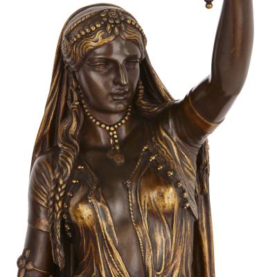 Ferdinand Barbedienne Two Orientalist patinated and gilt bronze figural torch res by Barbedienne