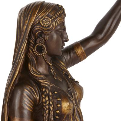 Ferdinand Barbedienne Two Orientalist patinated and gilt bronze figural torch res by Barbedienne