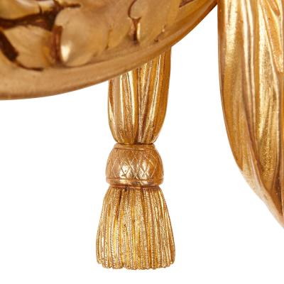 Four Neoclassical style gilt bronze two light sconces