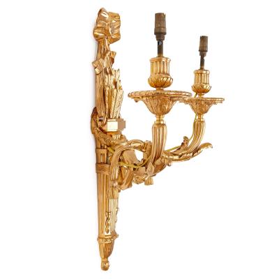Four Neoclassical style gilt bronze two light sconces