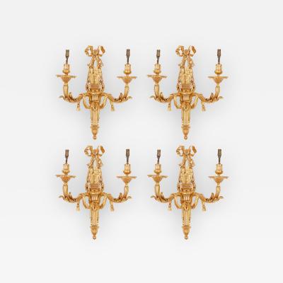 Four Neoclassical style gilt bronze two light sconces