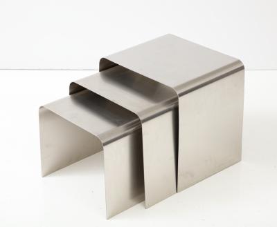 Fran ois Monnet Rare set of three nesting tables rendered in bent brushed stainless steel 