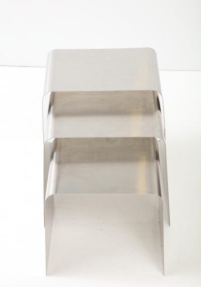 Fran ois Monnet Rare set of three nesting tables rendered in bent brushed stainless steel 