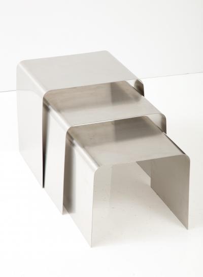 Fran ois Monnet Rare set of three nesting tables rendered in bent brushed stainless steel 