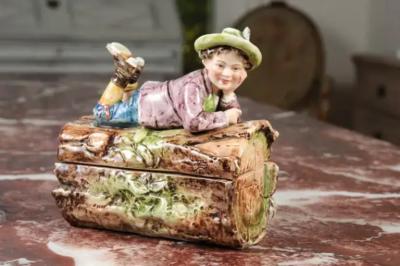French 19th Century Barbotine Bonbon Box Depicting a Boy Laying on a Tree Trunk