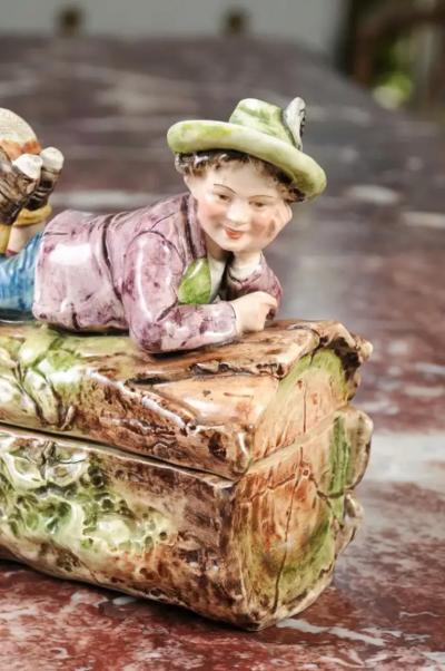 French 19th Century Barbotine Bonbon Box Depicting a Boy Laying on a Tree Trunk
