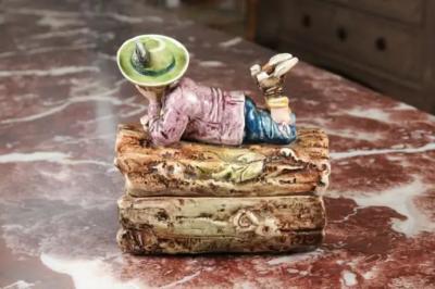 French 19th Century Barbotine Bonbon Box Depicting a Boy Laying on a Tree Trunk