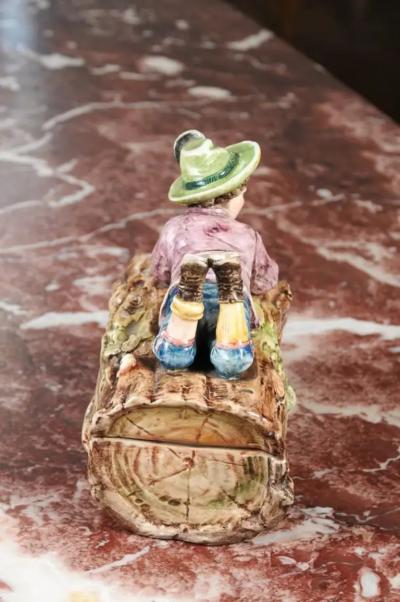French 19th Century Barbotine Bonbon Box Depicting a Boy Laying on a Tree Trunk