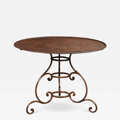 French 19th Century Round Iron Garden Table with Scrolling Base and Rusty Finish