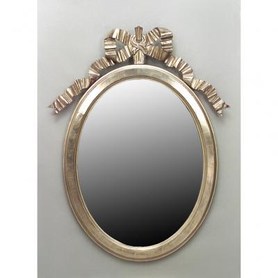 French Louis XVI style 20th Cent gilt oval vertical wall mirror with carved bo
