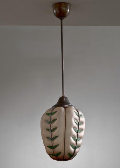 Glass pendant with metal leaves