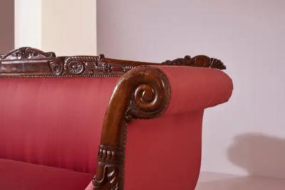 Henry Thomas Peters A carved walnut sofa with boat shaped form in the style of Henry Thomas Peters