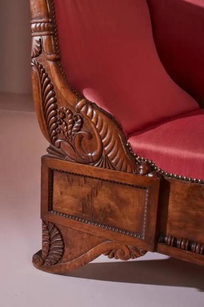 Henry Thomas Peters A carved walnut sofa with boat shaped form in the style of Henry Thomas Peters