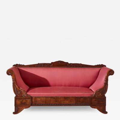 Henry Thomas Peters A carved walnut sofa with boat shaped form in the style of Henry Thomas Peters