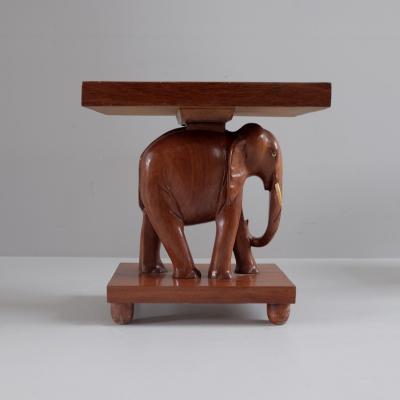 Herd of 1950s teak elephant side tables sold as pairs France