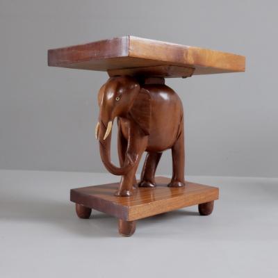Herd of 1950s teak elephant side tables sold as pairs France