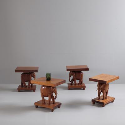 Herd of 1950s teak elephant side tables sold as pairs France