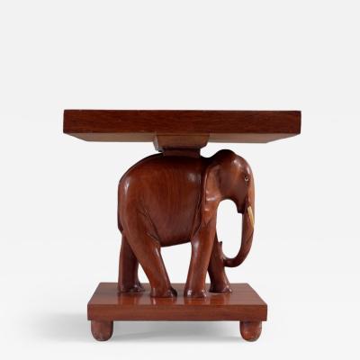 Herd of 1950s teak elephant side tables sold as pairs France