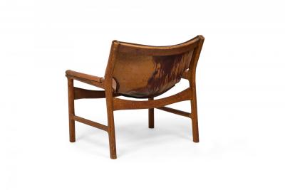Illum Wikkels Danish Mid Century Caramel Leather and Oak Sling Design Lounge Ch