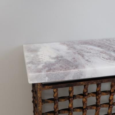 Intricate 1950s twisted iron radiator cover console with later marble top