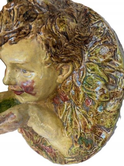 Italian Majolica porcelain round wall plaque with a cupid hold hands in front of