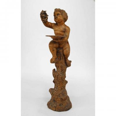 Italian Renaissance style stripped pedestal with cupid holding grapes