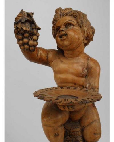 Italian Renaissance style stripped pedestal with cupid holding grapes