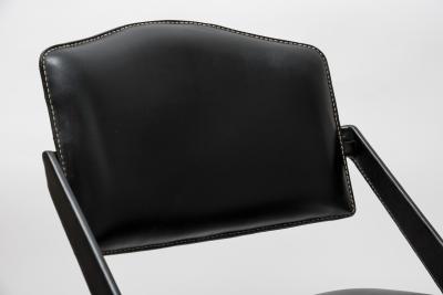 Jacques Adnet Pair oStitched Leather armchairs by Jacques Adnet