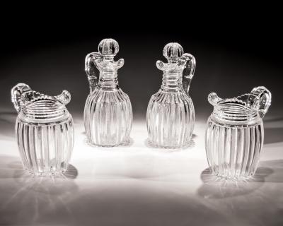 John Blades AN EXCEPTIONAL SUITE OF PILLAR FILE CUT GLASS JUGS BY JOHN BLADES