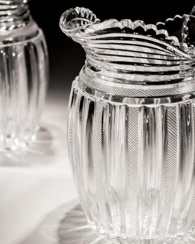 John Blades AN EXCEPTIONAL SUITE OF PILLAR FILE CUT GLASS JUGS BY JOHN BLADES